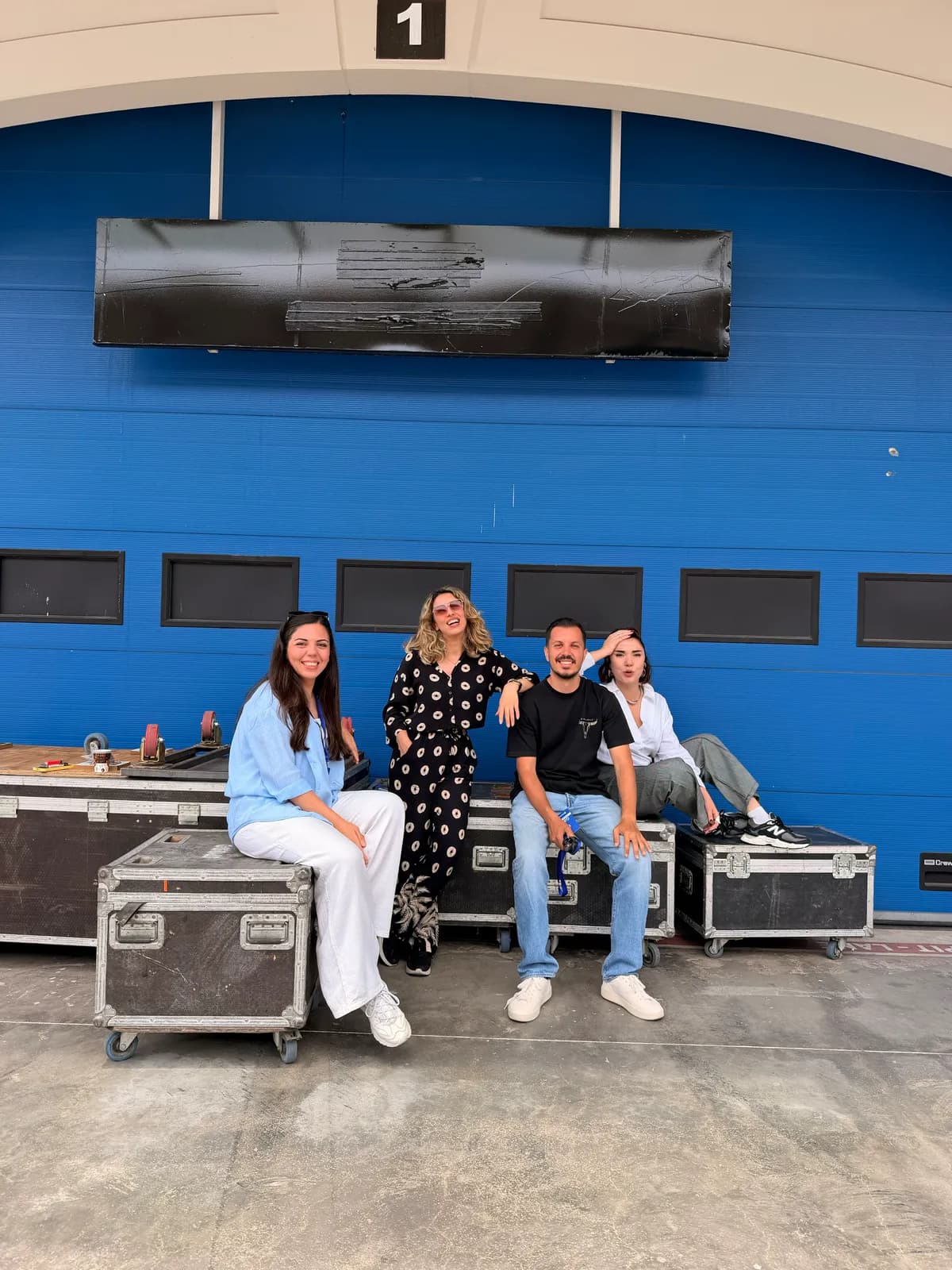 the team backstage, waiting on flight cases before showtime