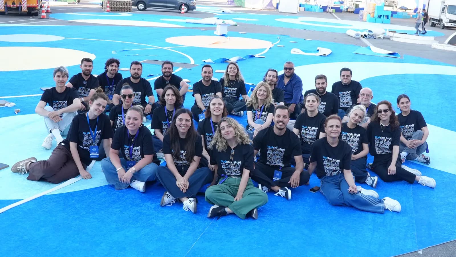 a wide team shot on the festival ground once the build is complete